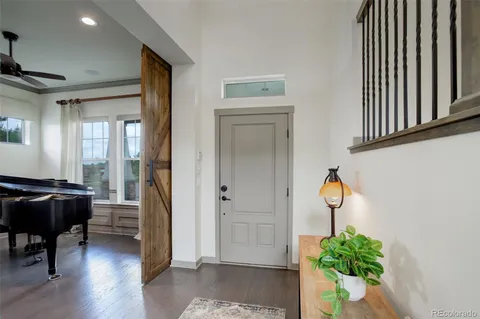 a hallway with a dining table and a chandelier