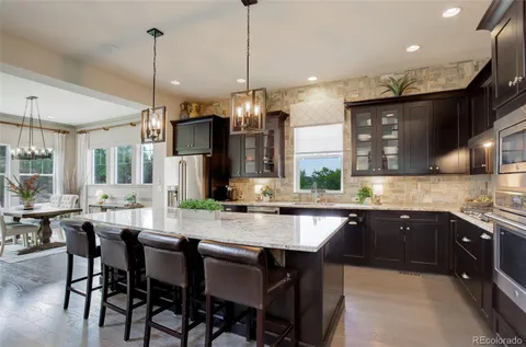 a kitchen with lots of counter space and dining table
