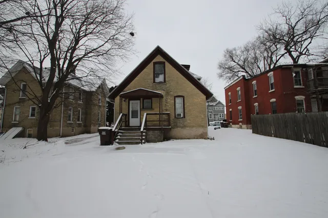 a view of a house with a snow on the road