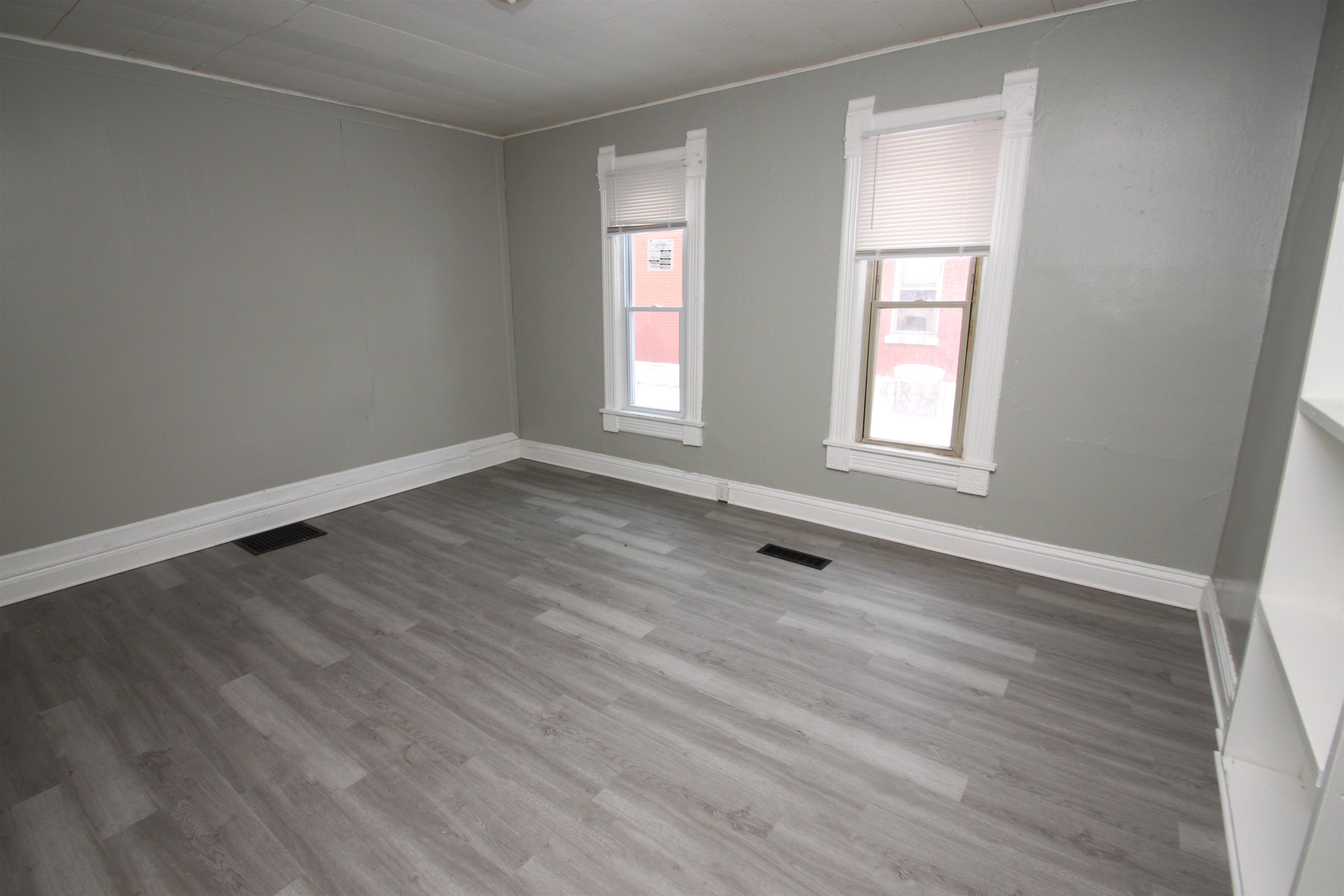 328 South Prospect Street Rockford, IL 61104 - Photo 6 of 14 an empty room with wooden floor and windows