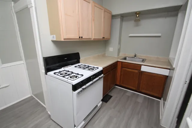 a view of kitchen with refrigerator and window