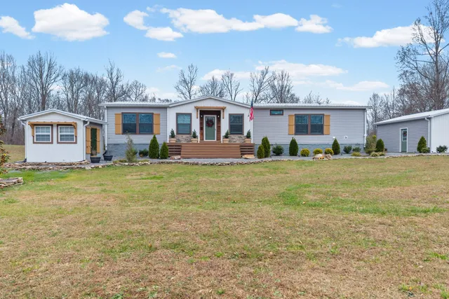 a front view of house with yard and green space