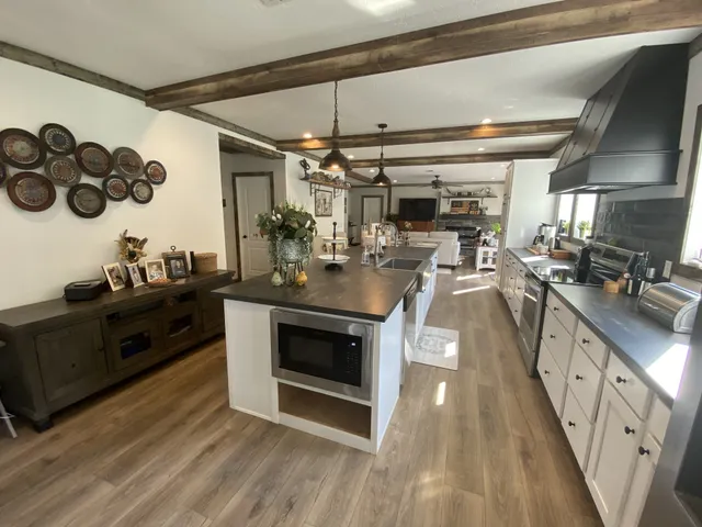 a kitchen with a sink appliances and cabinets