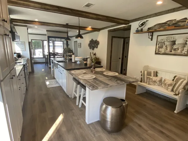 a dining hall with granite countertop a stove and white cabinets