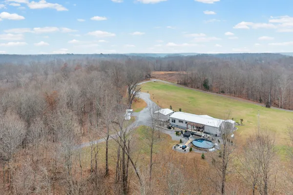 a living room with furniture a flat screen tv and a large window