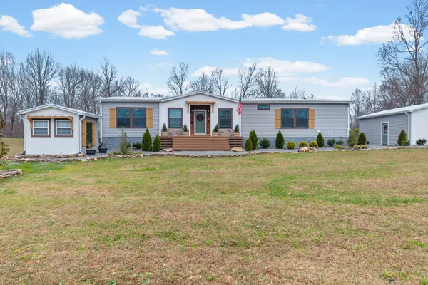 a front view of house with yard and green space