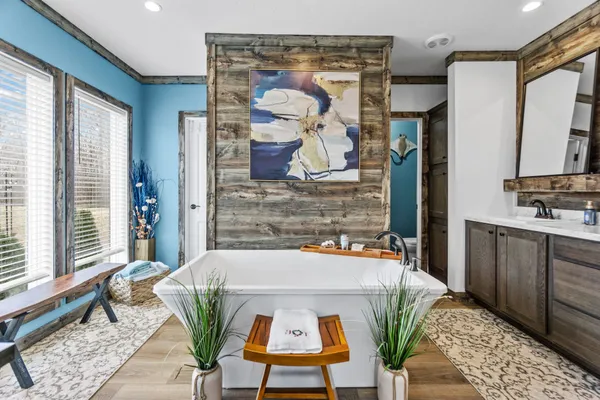 a view of a hallway with wooden floor and glass door