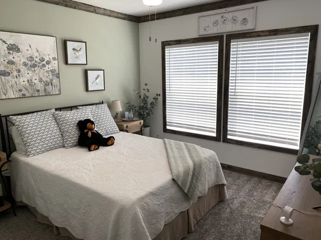 a bedroom with a bed and a window