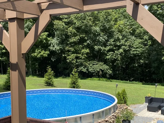 a view of a swimming pool with a yard
