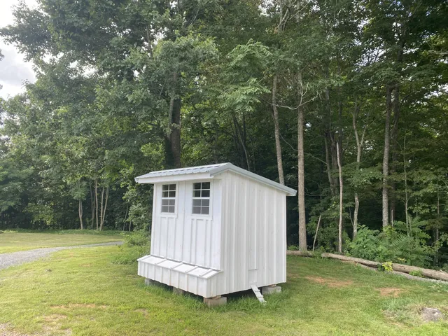 a view of backyard with small cabin