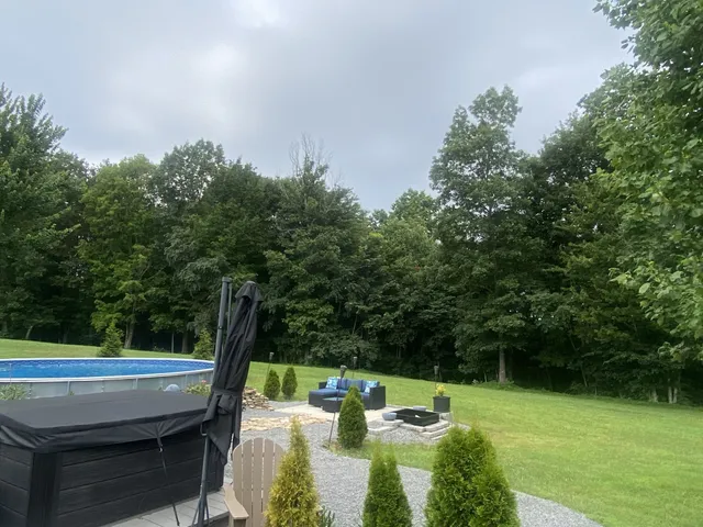 a view of backyard with seating area and green space