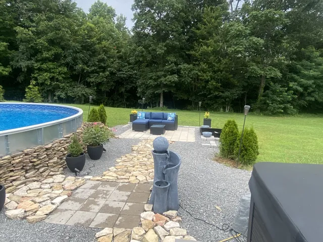a view of a patio with couches table and chairs and potted plants