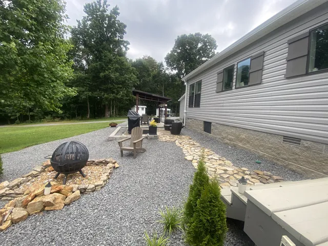 a view of a backyard with sitting area