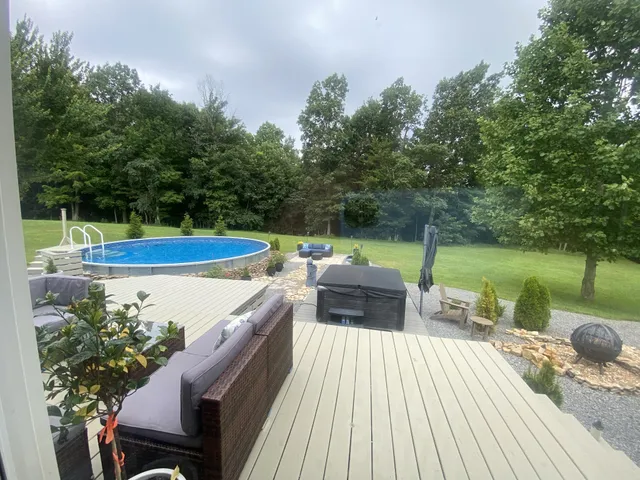 swimming pool view with a seating space