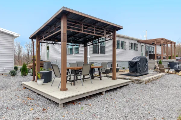 a view of a house with backyard and sitting area