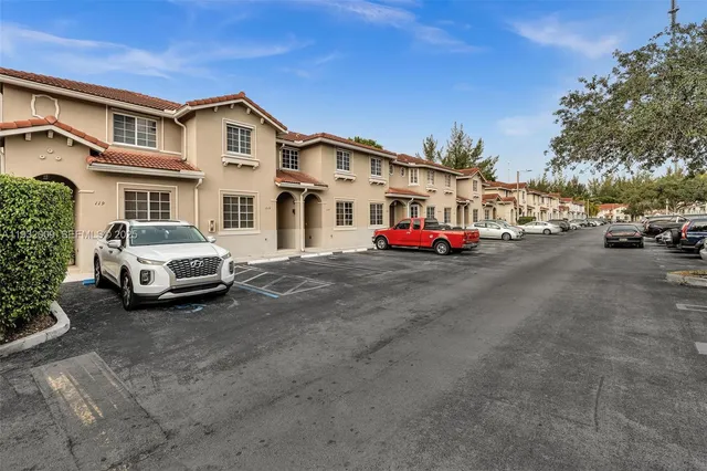 a car parked in front of a white house