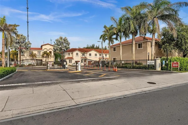 a front view of multiple houses with yard