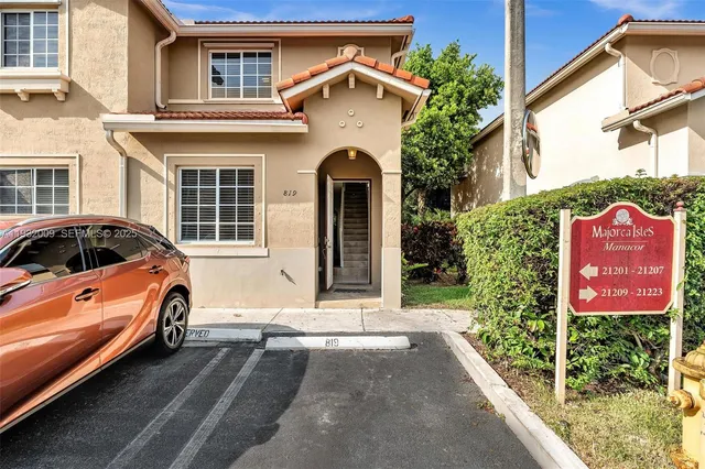 a front view of a house with parking area