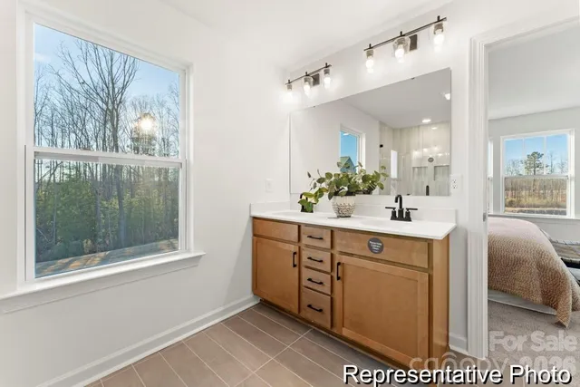 a spacious bathroom with a double vanity sink and a mirror