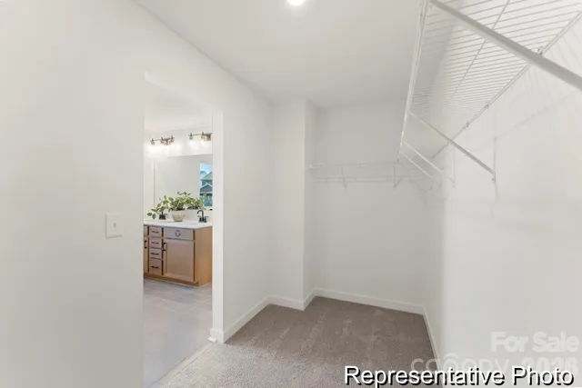 a view of an empty room and kitchen