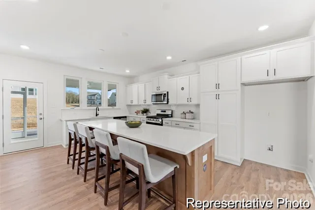 a view of kitchen with cabinets table and chairs