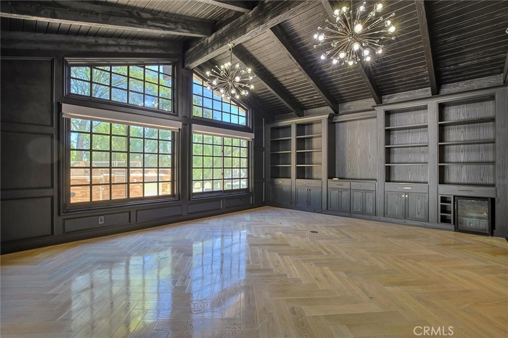 5839 Jed Smith Road Hidden Hills, CA 91302 - Photo 14 of 46 a view of an empty room with a fireplace and a large window