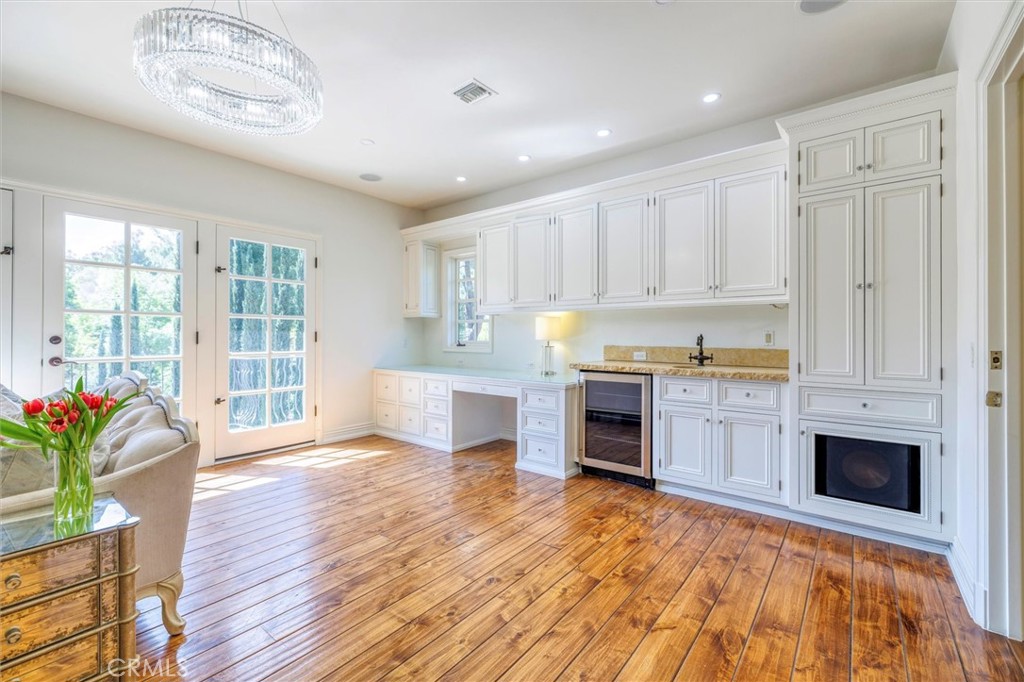 5839 Jed Smith Road Hidden Hills, CA 91302 - Photo 17 of 46 a open kitchen with granite countertop a stove a sink dishwasher and a refrigerator with wooden floor