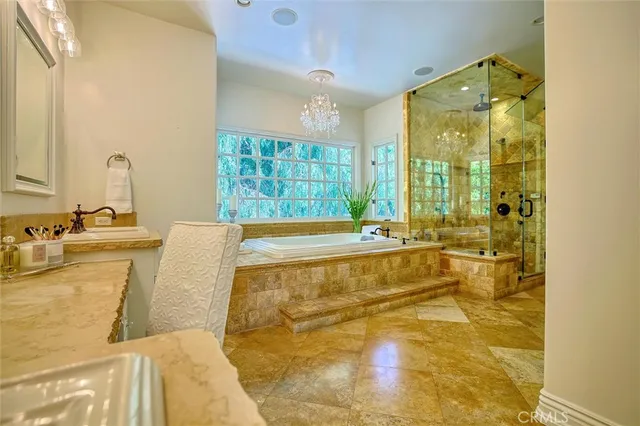 a spacious bathroom with a granite countertop sink and a mirror