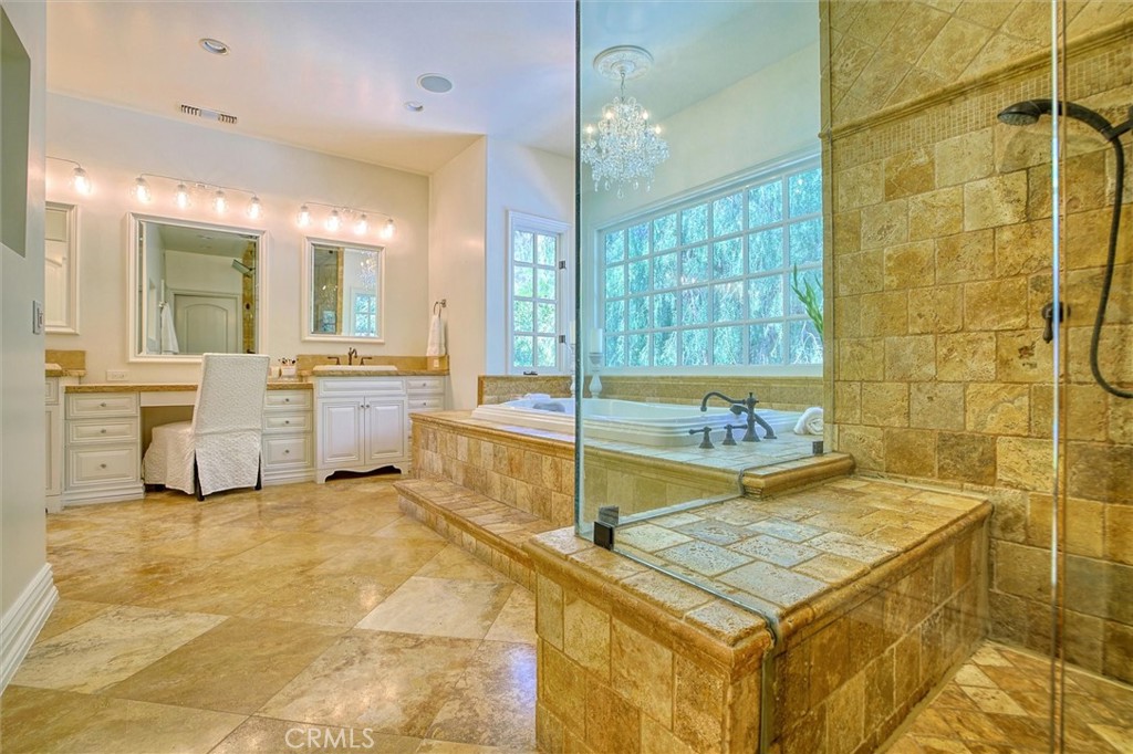 5839 Jed Smith Road Hidden Hills, CA 91302 - Photo 22 of 46 a spacious bathroom with a granite countertop sink and a mirror