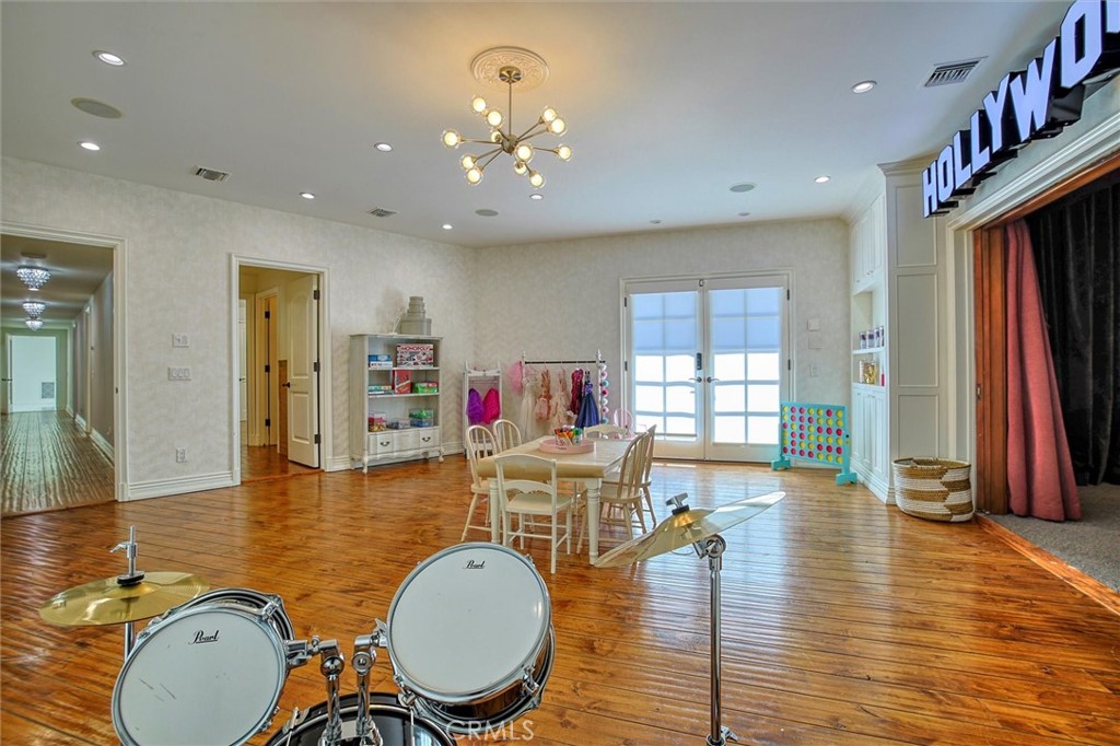 5839 Jed Smith Road Hidden Hills, CA 91302 - Photo 33 of 46 a dining room with wooden floor a glass table and chairs