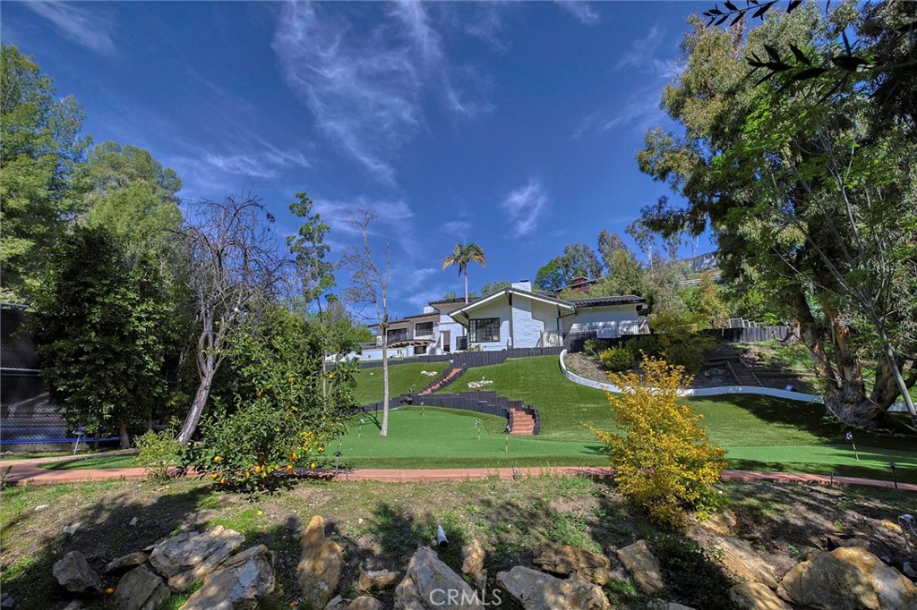 5839 Jed Smith Road Hidden Hills, CA 91302 - Photo 41 of 46 a front view of a house with a yard