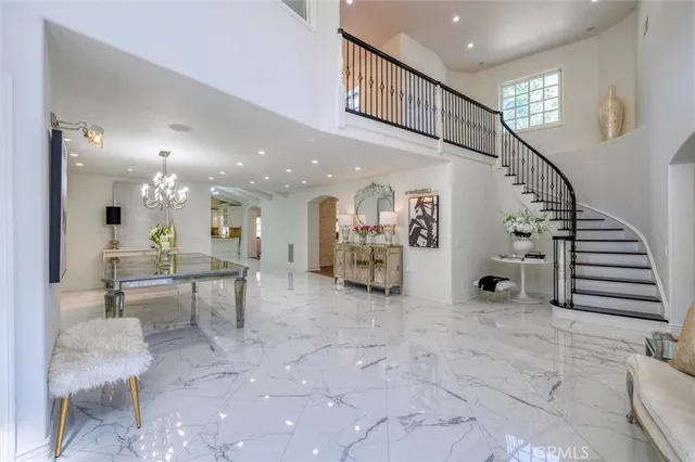 a view of a dining room with furniture and a chandelier