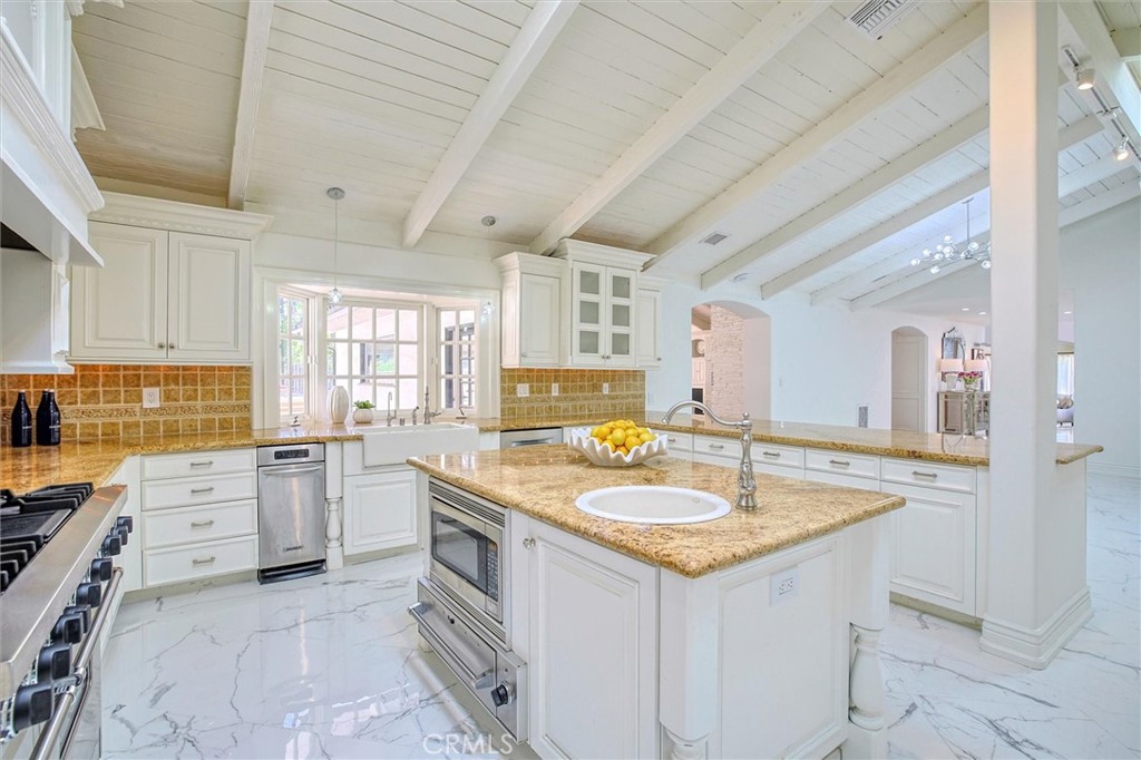 5839 Jed Smith Road Hidden Hills, CA 91302 - Photo 7 of 46 a kitchen with granite countertop a sink stove and cabinets