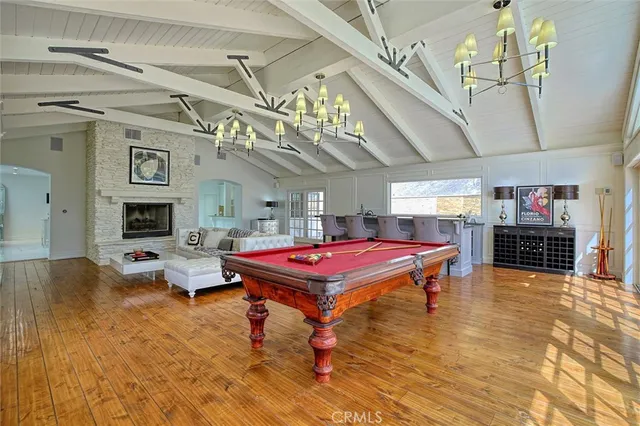 a living room with kitchen island granite countertop wooden floor and stainless steel appliances