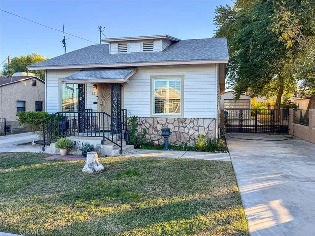 a living room with wooden floor furniture and a ceiling fan