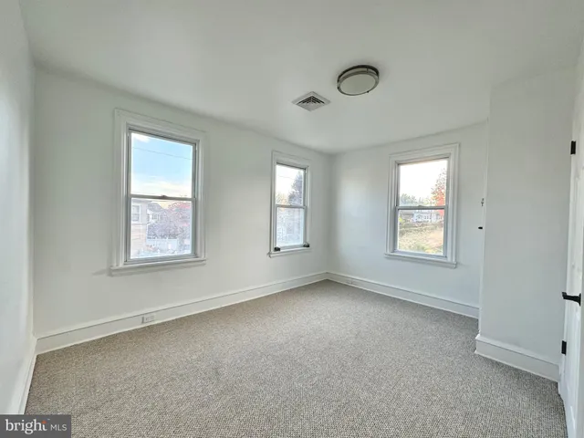 a kitchen with a sink stove top oven and cabinets