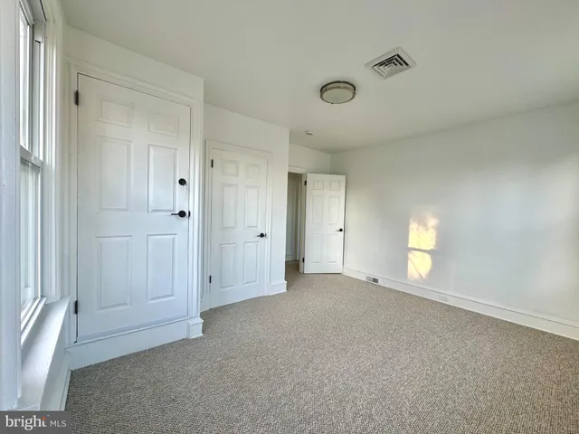 a large kitchen with stainless steel appliances a large counter top and a wooden floors