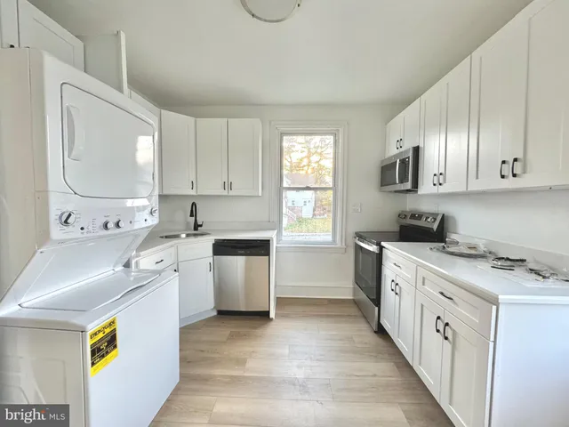 a kitchen with a wooden floor and window