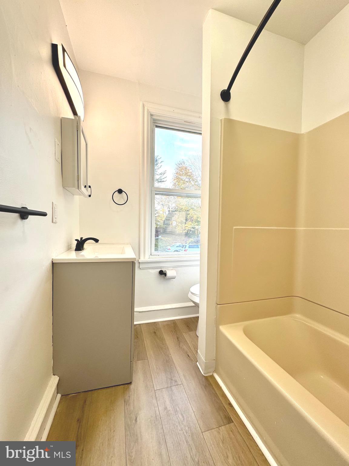 1121 Rosedale Avenue Wilmington, DE 19809 - Photo 21 of 37 a bathroom with a tub a sink and a large mirror