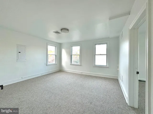 a view of an empty room and a window