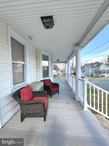 a bedroom with furniture and a large window