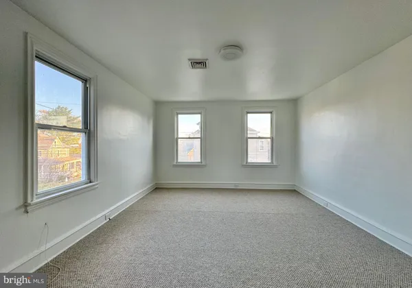 a view of an empty room with windows