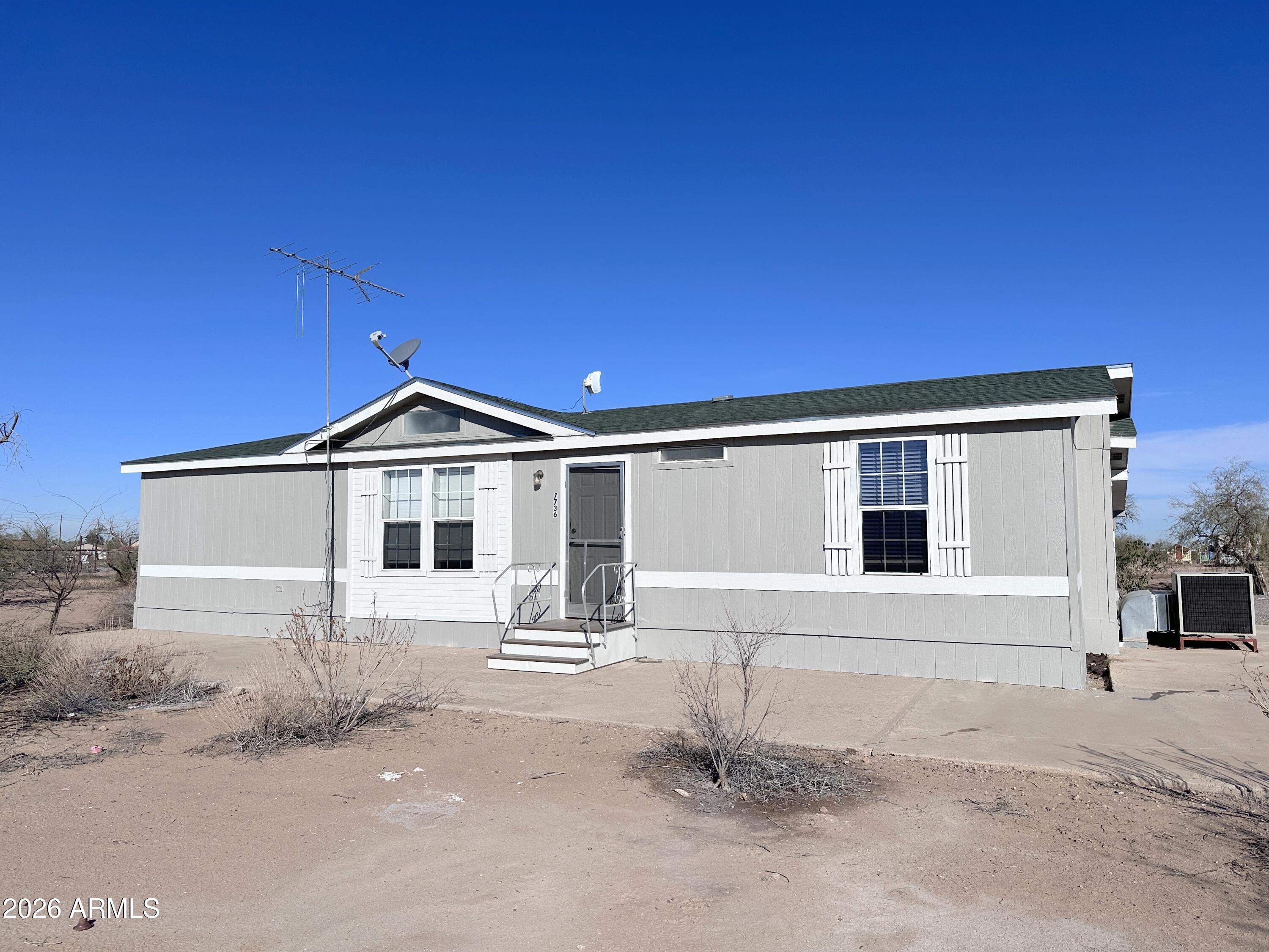 7736 West Alsdorf Road Arizona City, AZ 85193 - Photo 1 of 45 a front view of a house with a yard