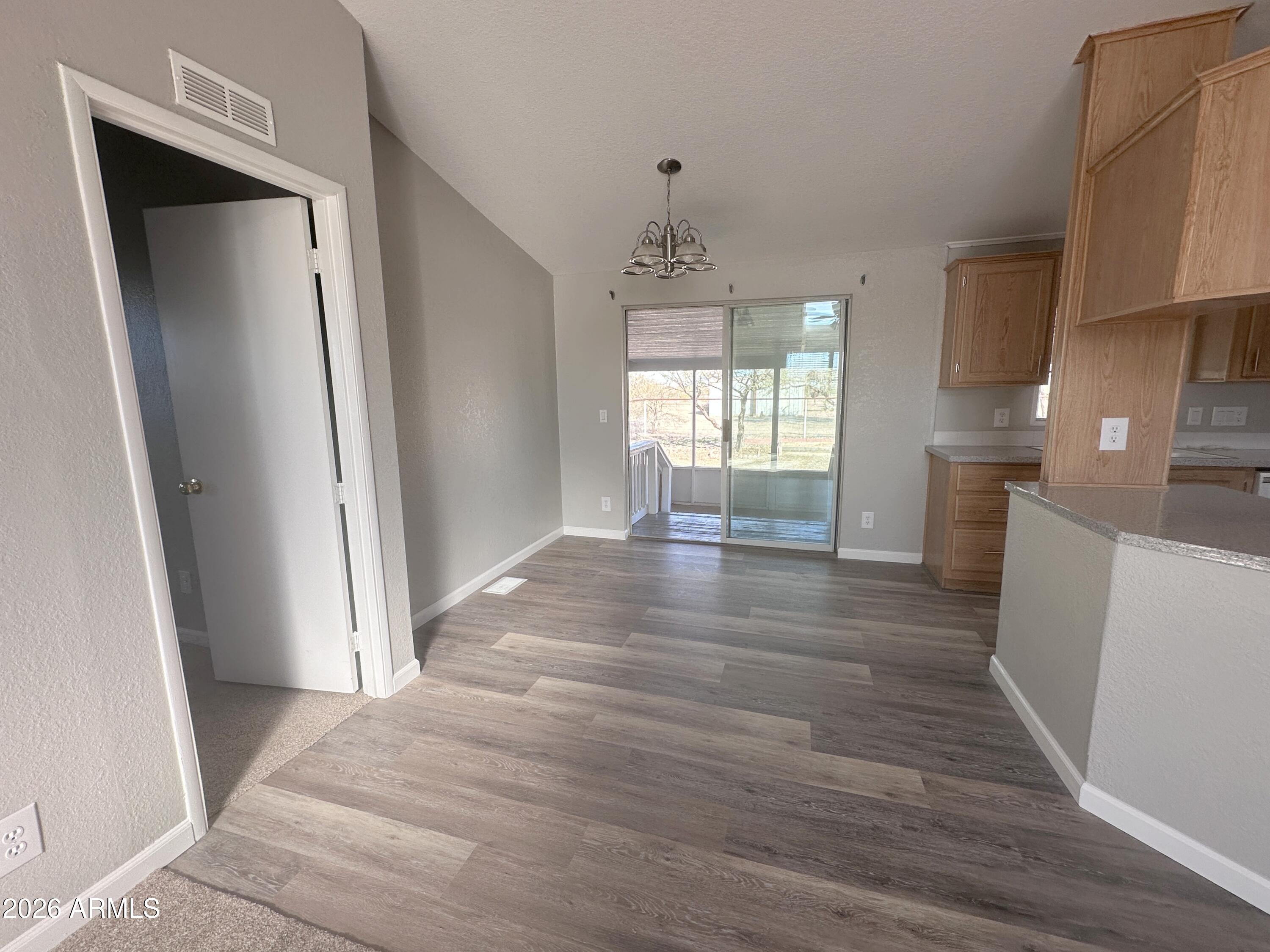 7736 West Alsdorf Road Arizona City, AZ 85193 - Photo 11 of 45 a view of empty room with wooden floor and fan