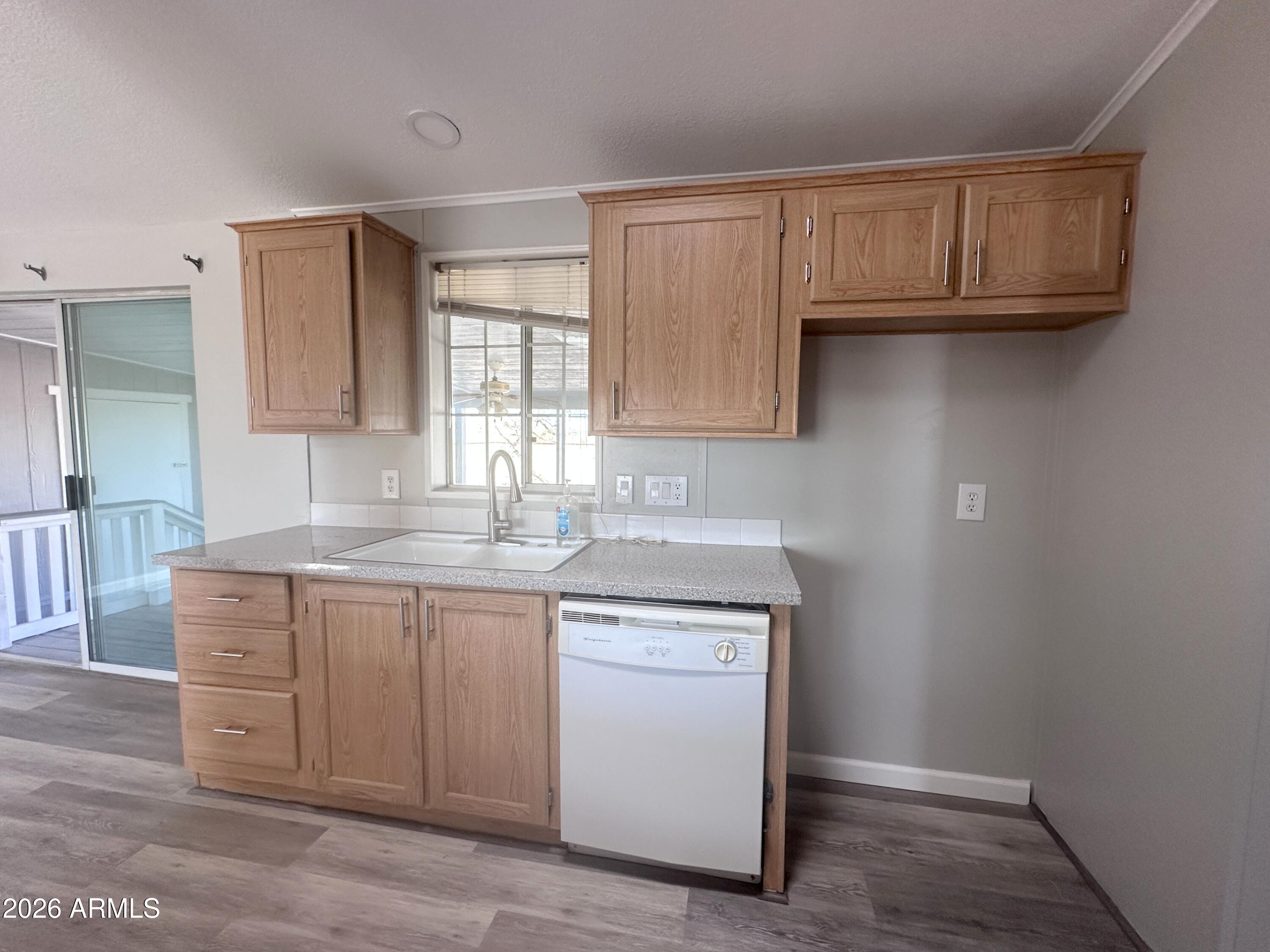 7736 West Alsdorf Road Arizona City, AZ 85193 - Photo 15 of 45 a kitchen with a sink cabinets and a window