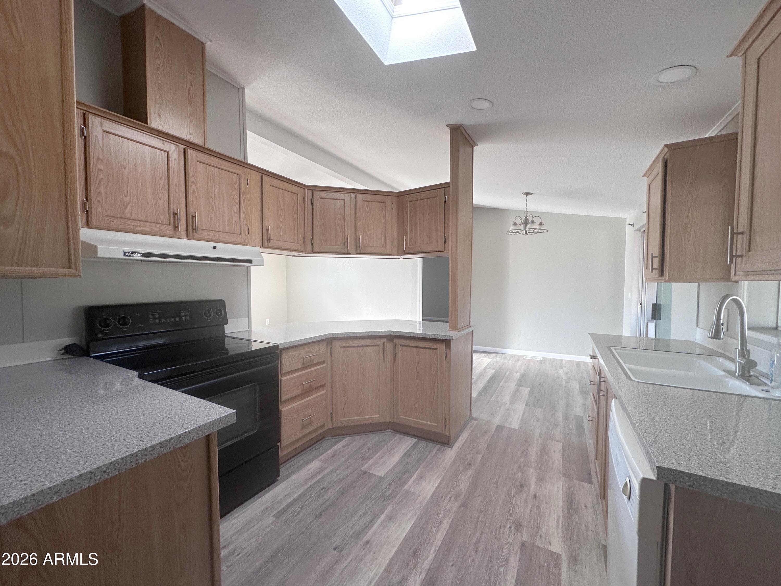 7736 West Alsdorf Road Arizona City, AZ 85193 - Photo 16 of 45 a kitchen with a sink stove and cabinets