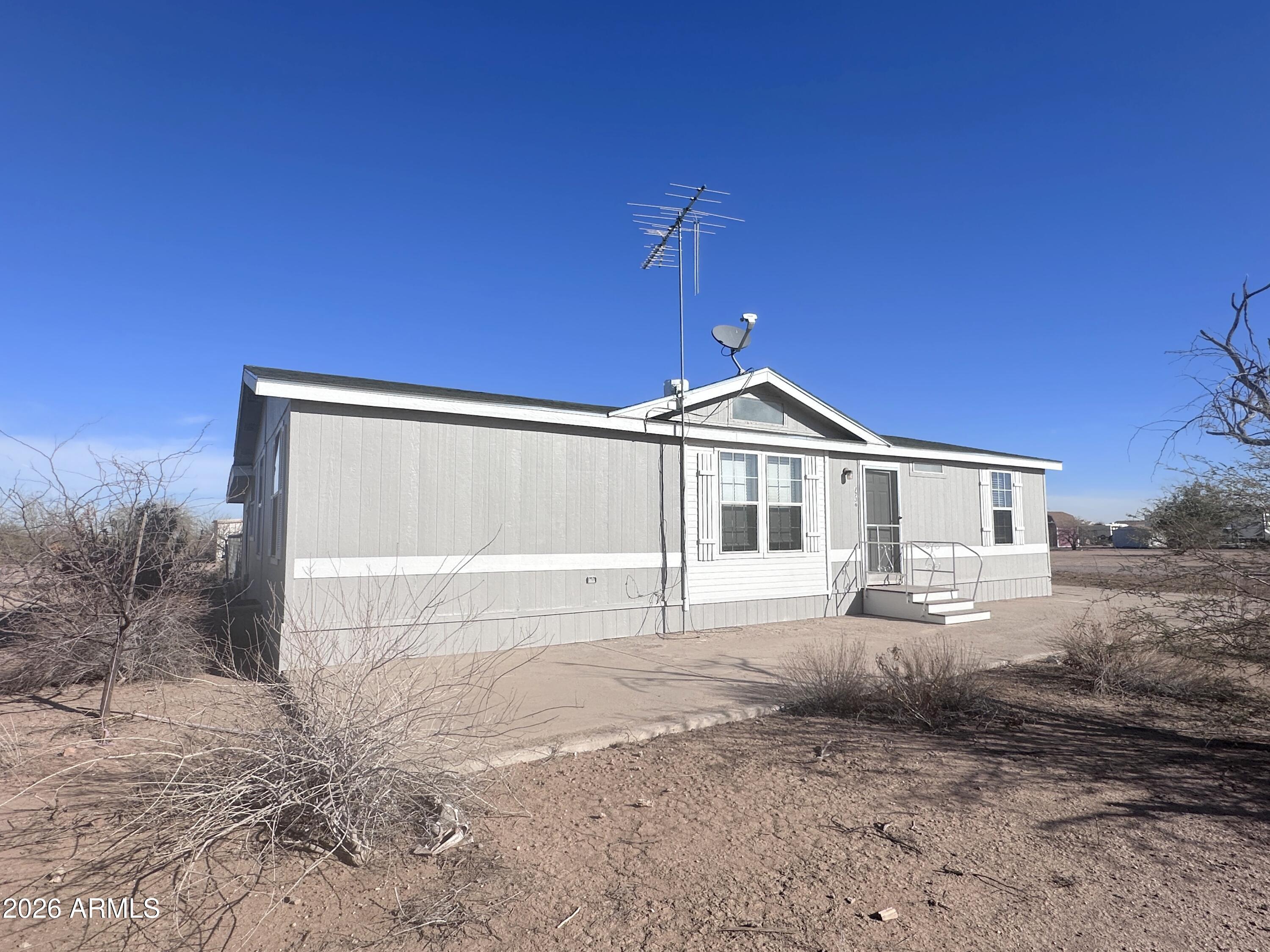 7736 West Alsdorf Road Arizona City, AZ 85193 - Photo 2 of 45 a front view of a house with a yard