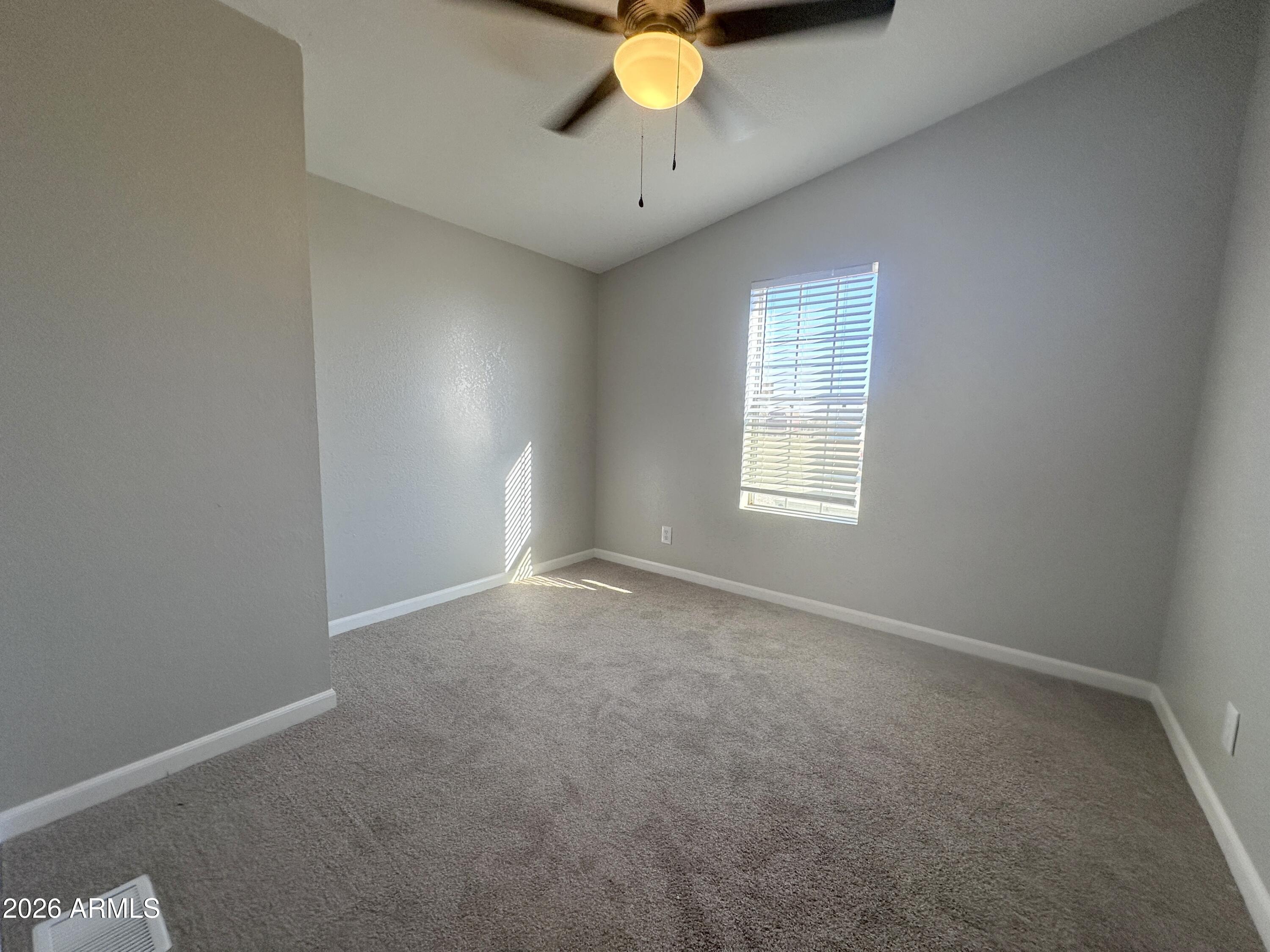 7736 West Alsdorf Road Arizona City, AZ 85193 - Photo 22 of 45 an empty room with a window and a ceiling fan