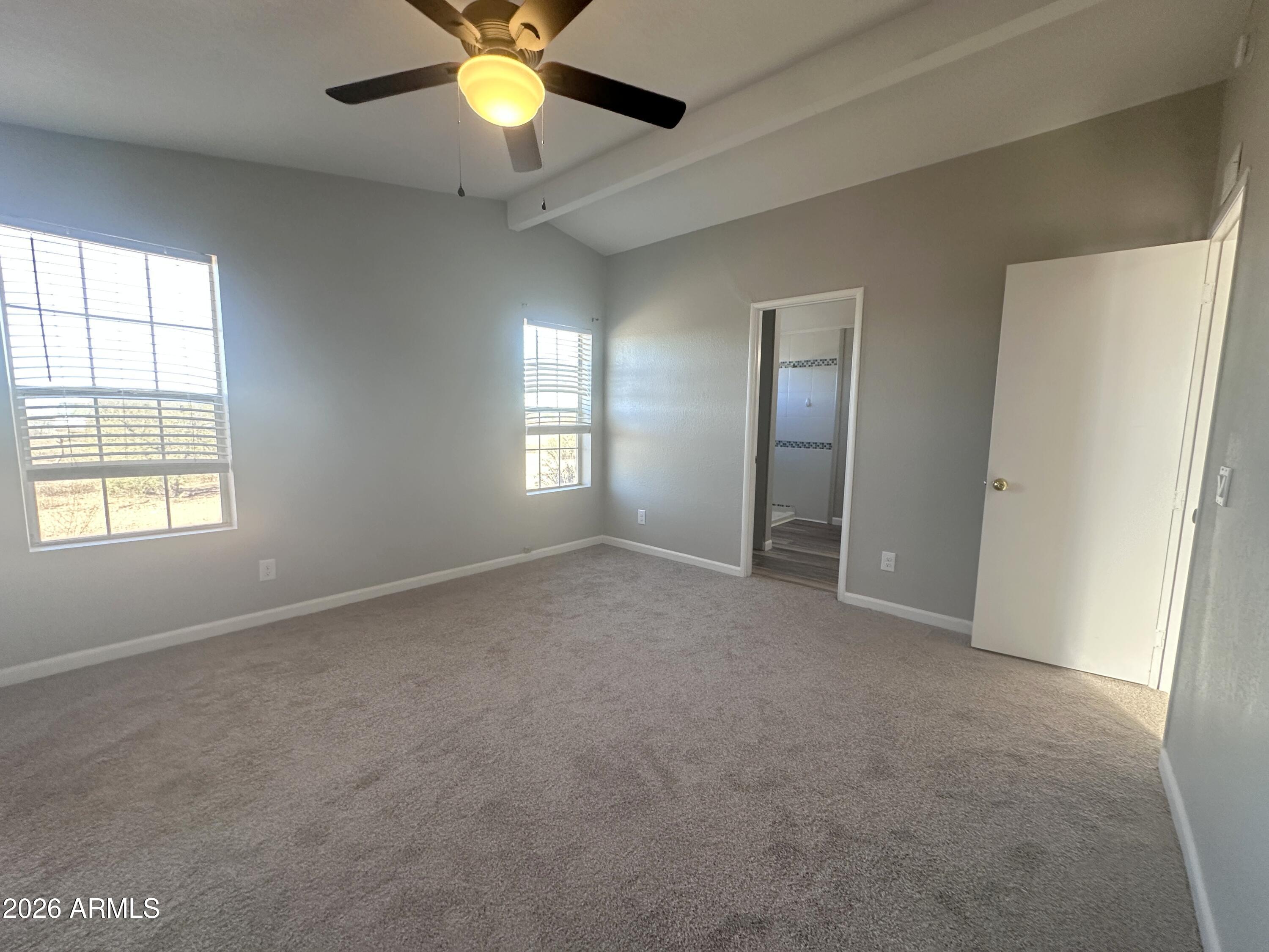 7736 West Alsdorf Road Arizona City, AZ 85193 - Photo 25 of 45 an empty room with windows and fan