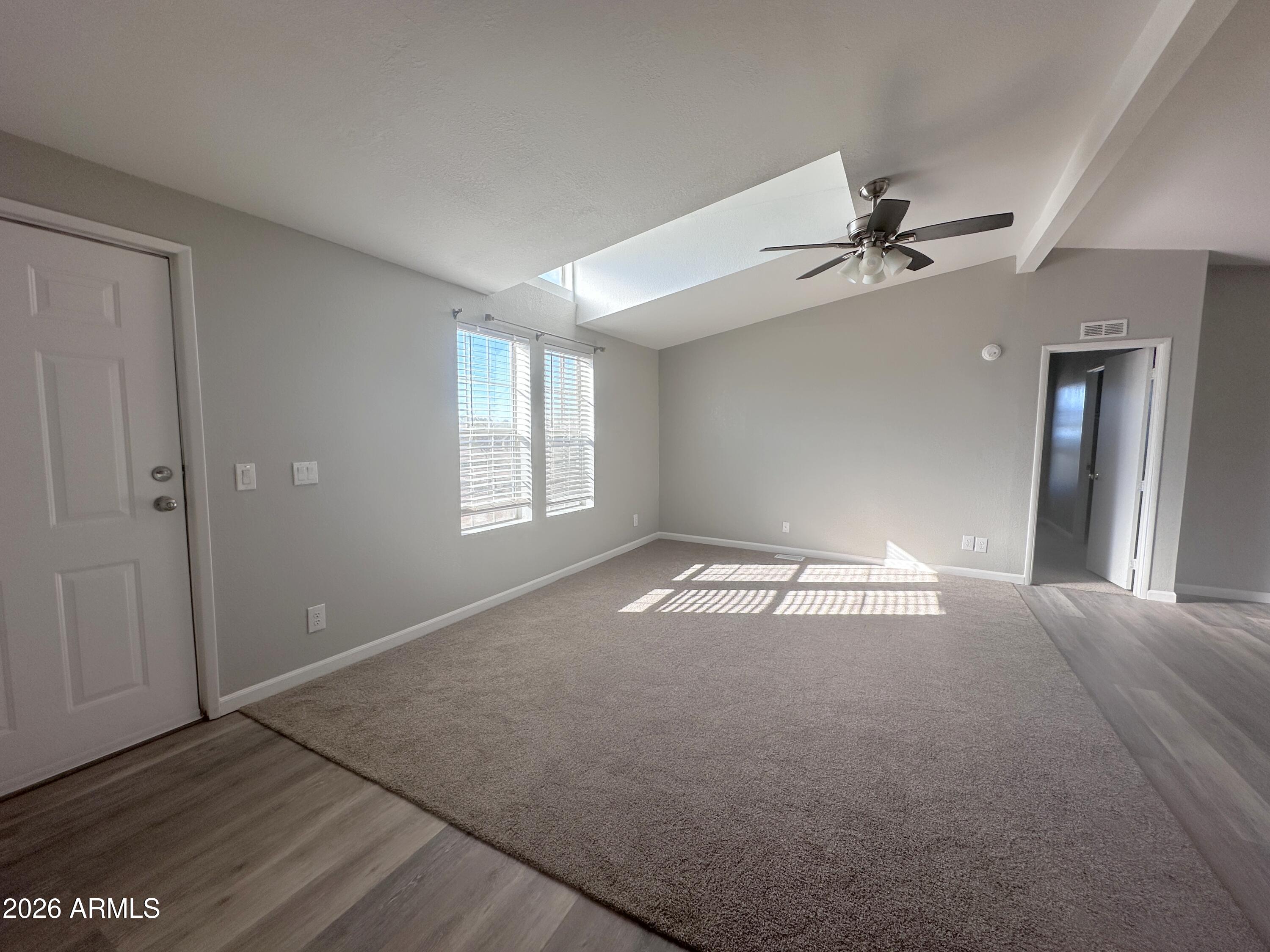7736 West Alsdorf Road Arizona City, AZ 85193 - Photo 7 of 45 a view of empty room with wooden floor and fan
